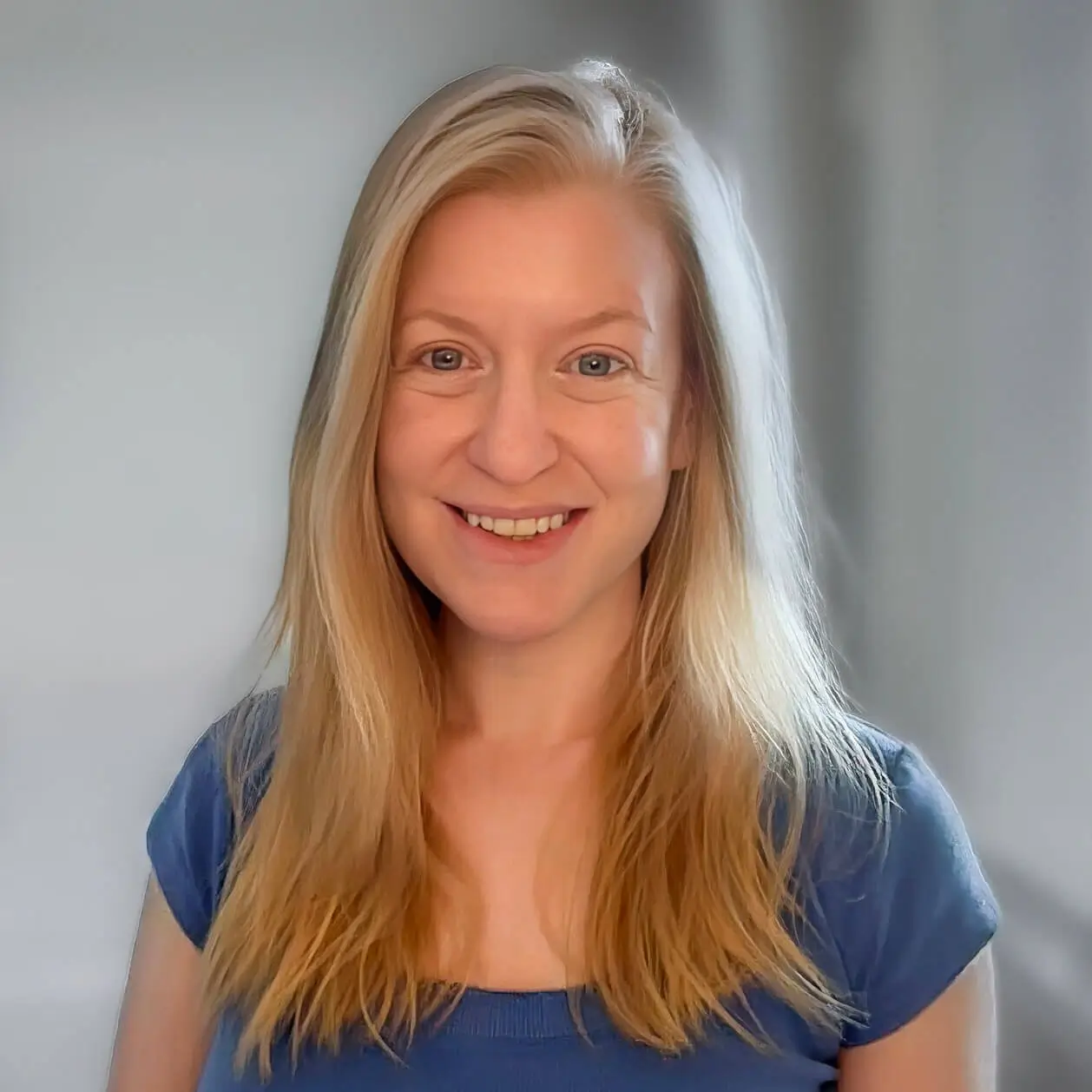 Alicia Hurst smiling, photographed indoors